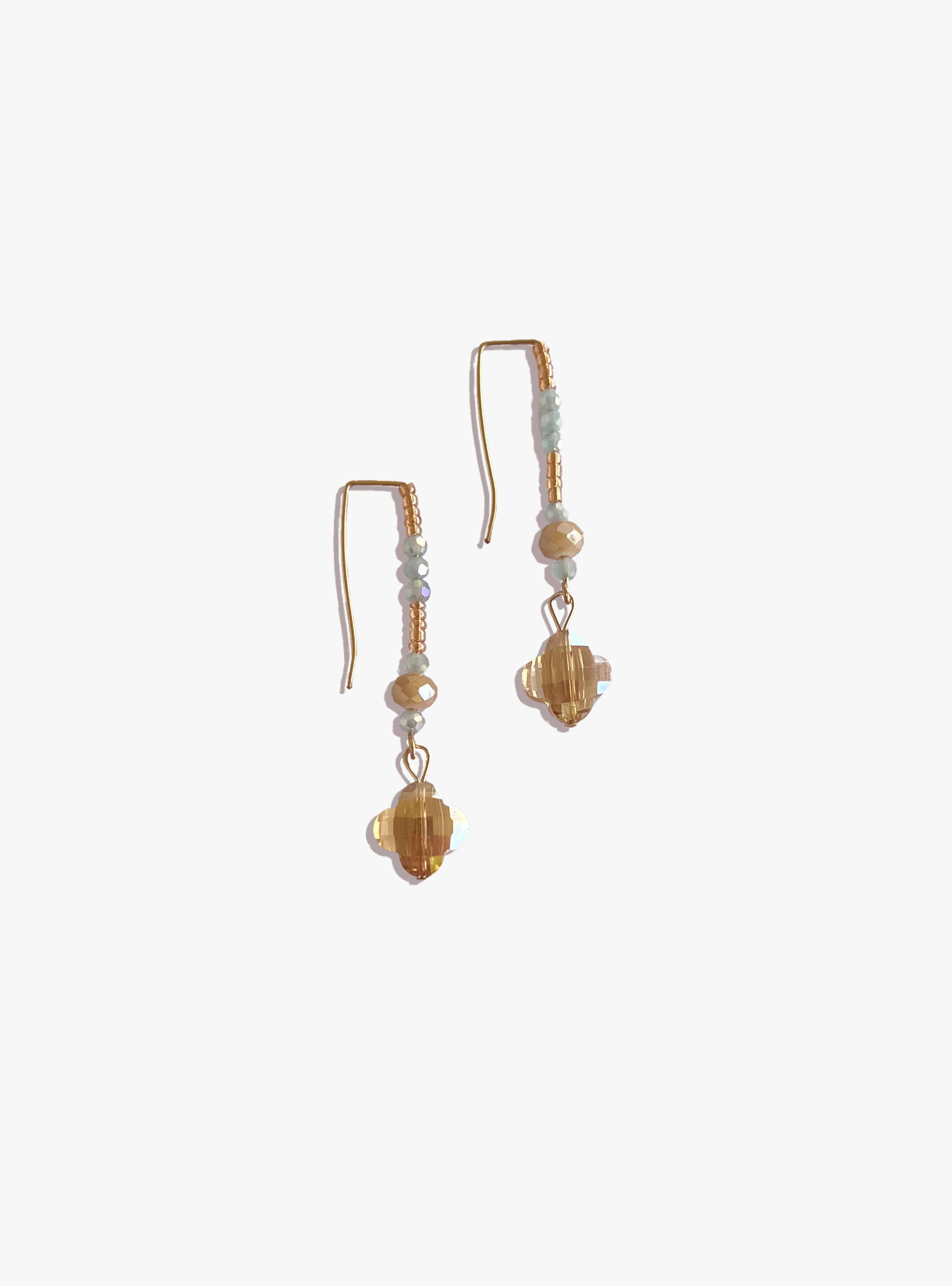 Pair of gold and beige beaded earrings on a white background