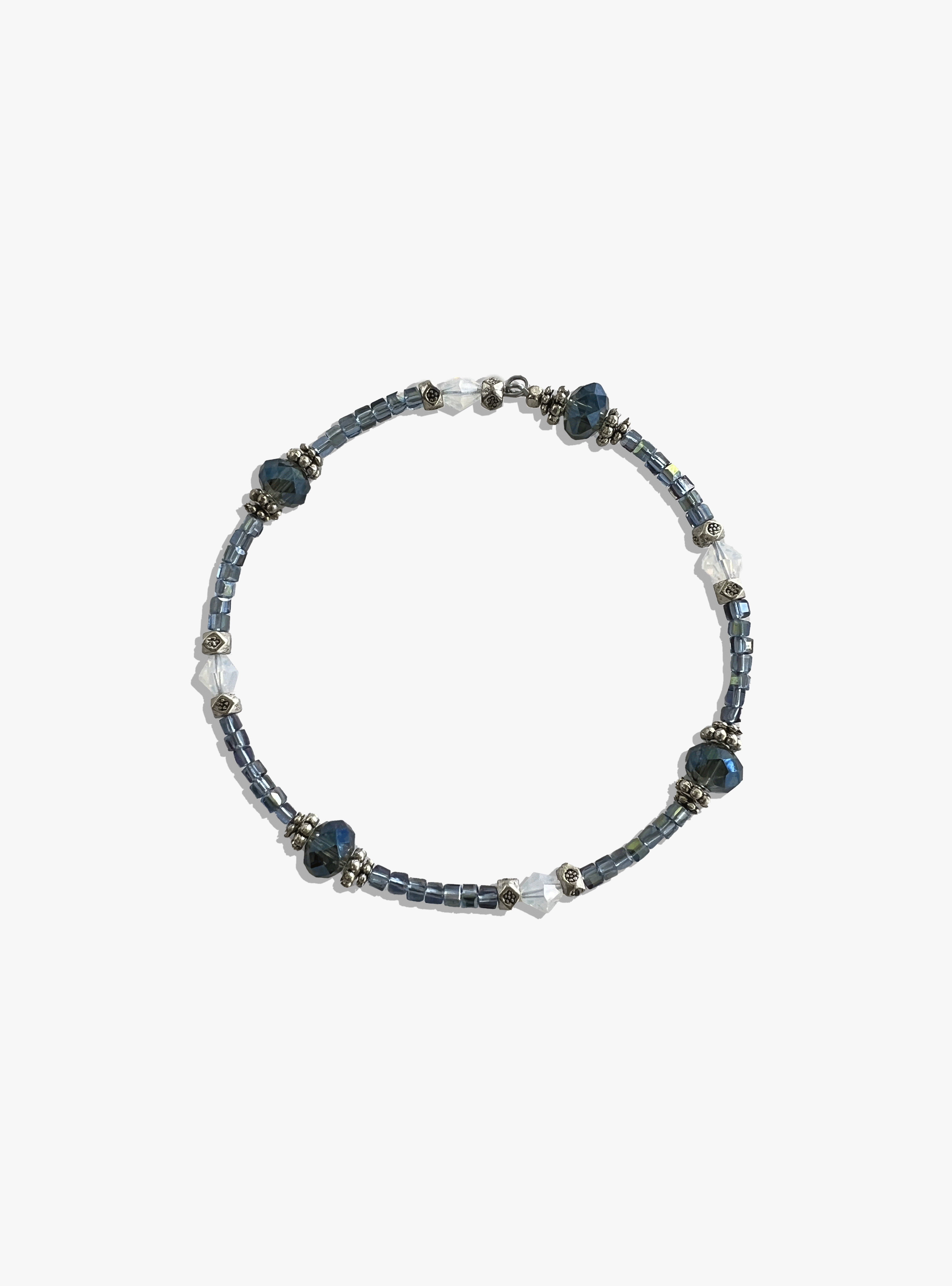 Beaded bracelet with blue and silver beads on a white background