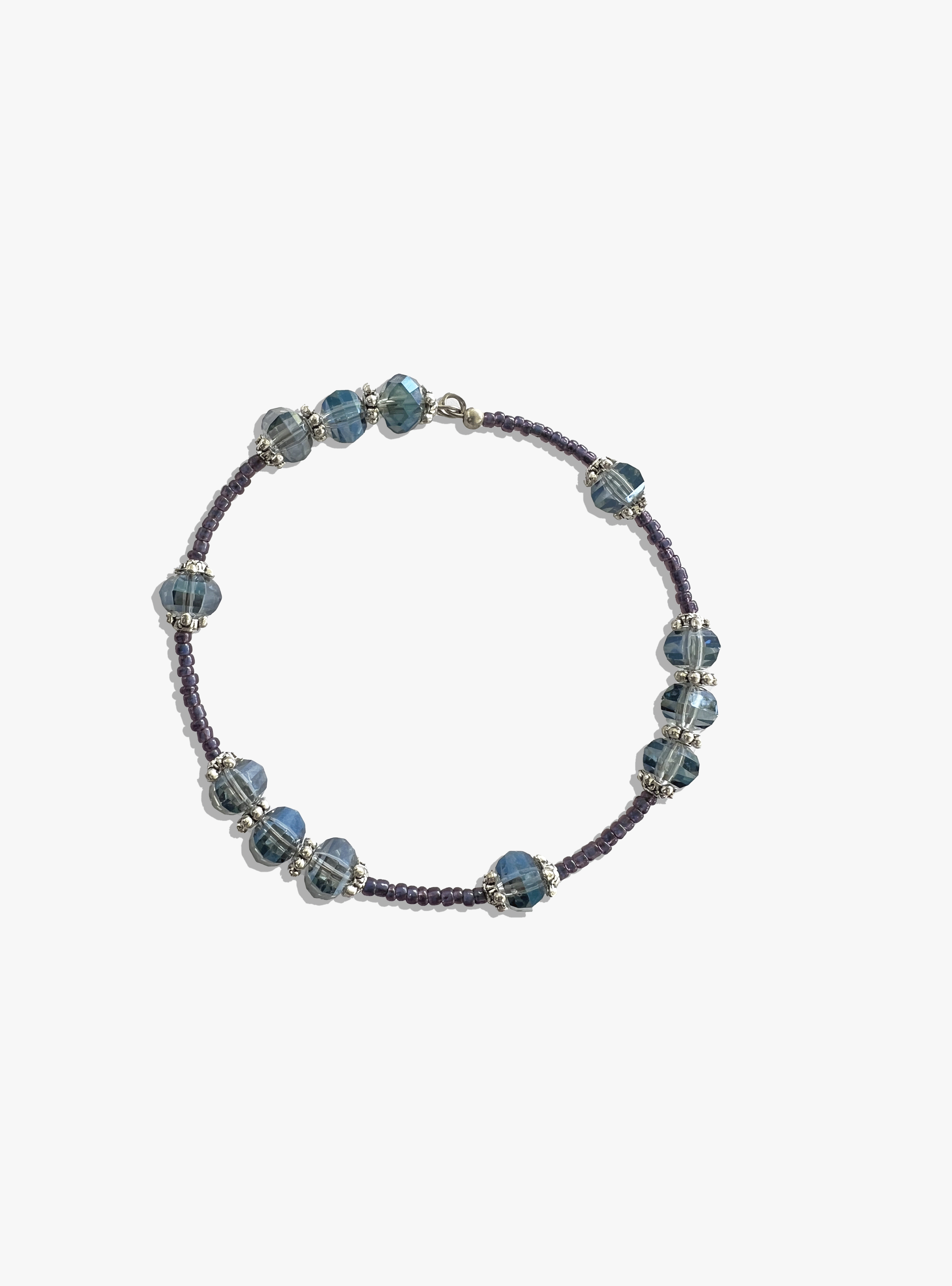 Beaded bracelet with blue and purple beads on a white background