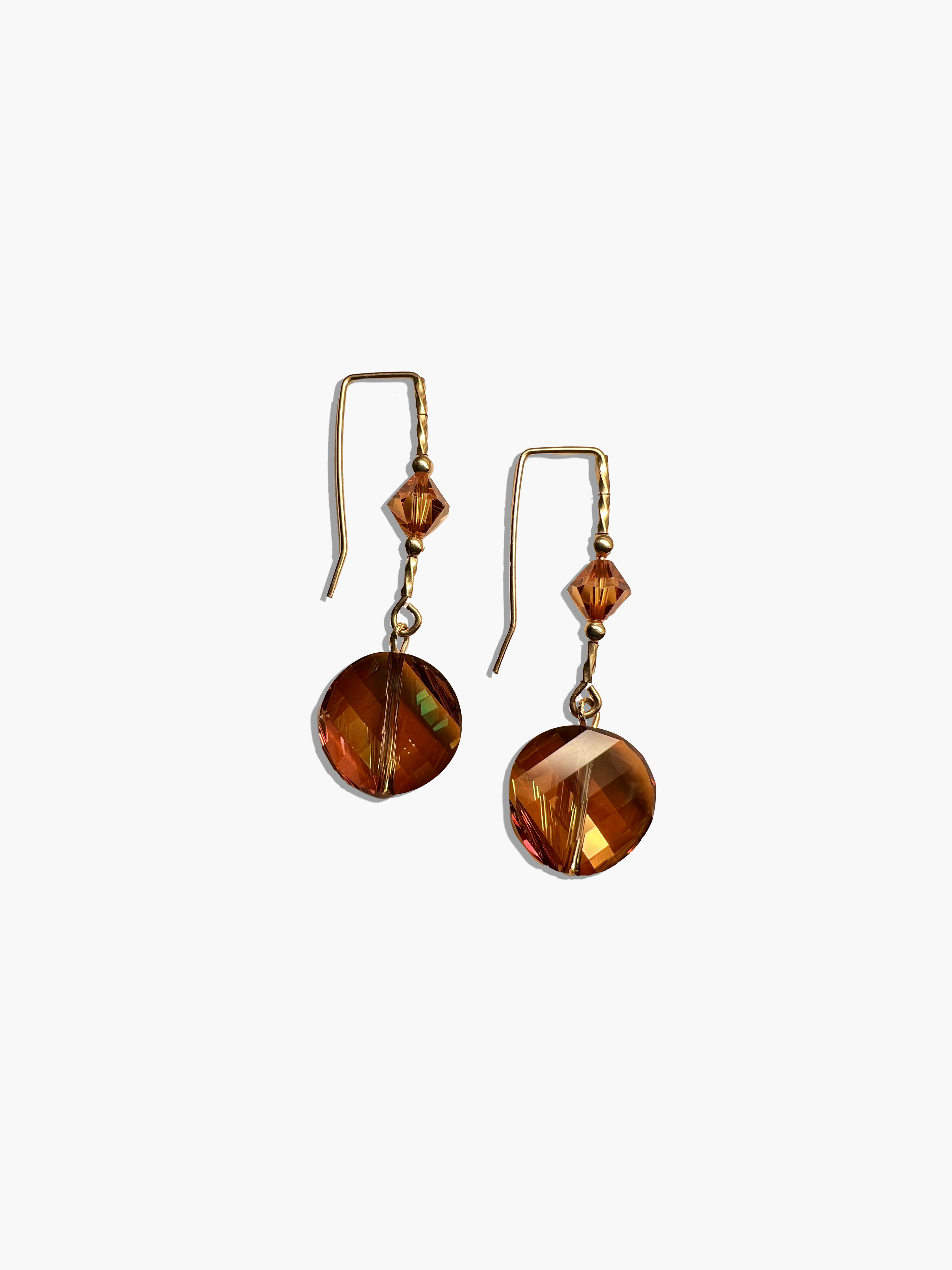 Pair of amber-colored earrings on a white background