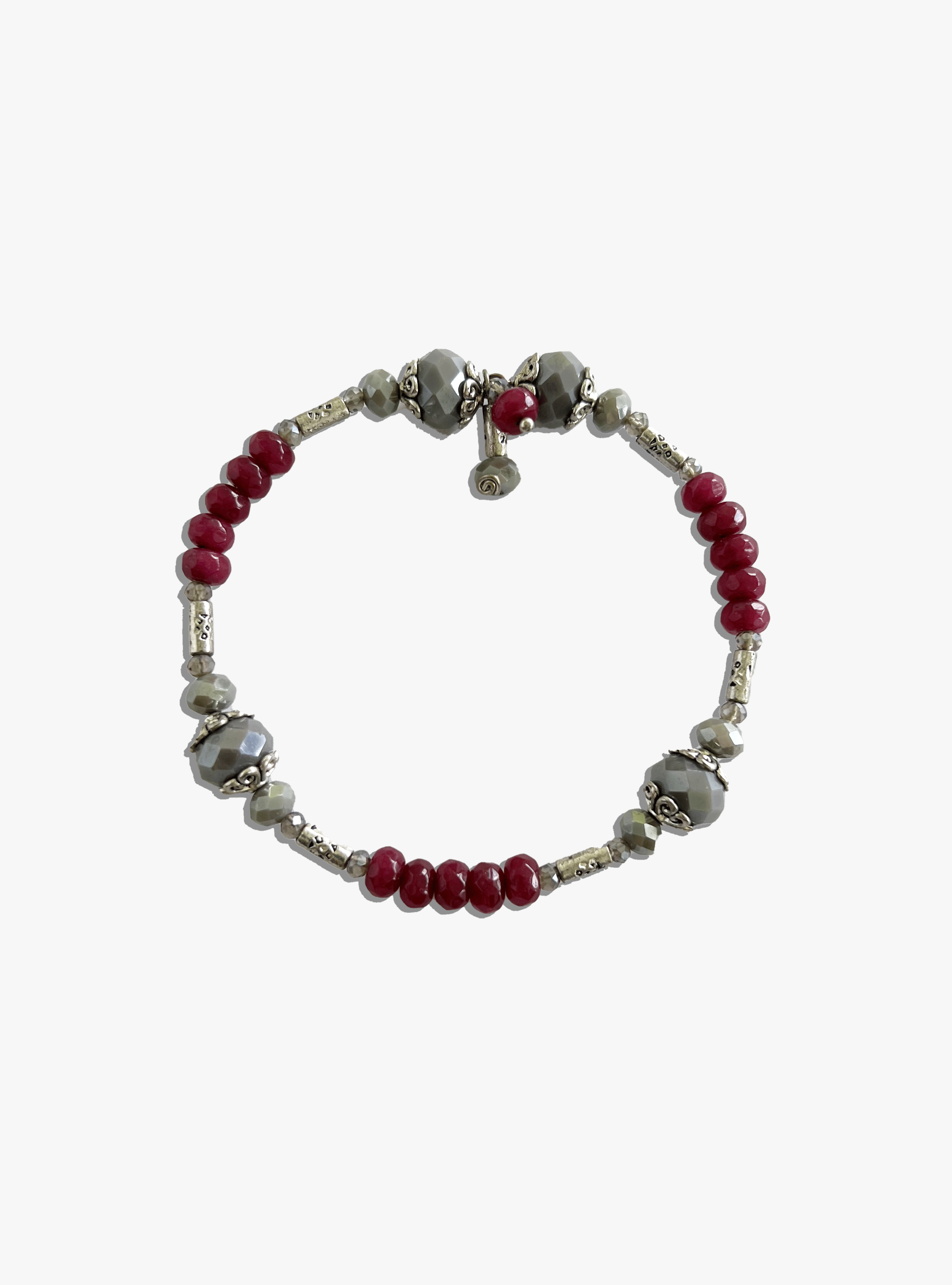 Bracelet with red and silver beads on a white background