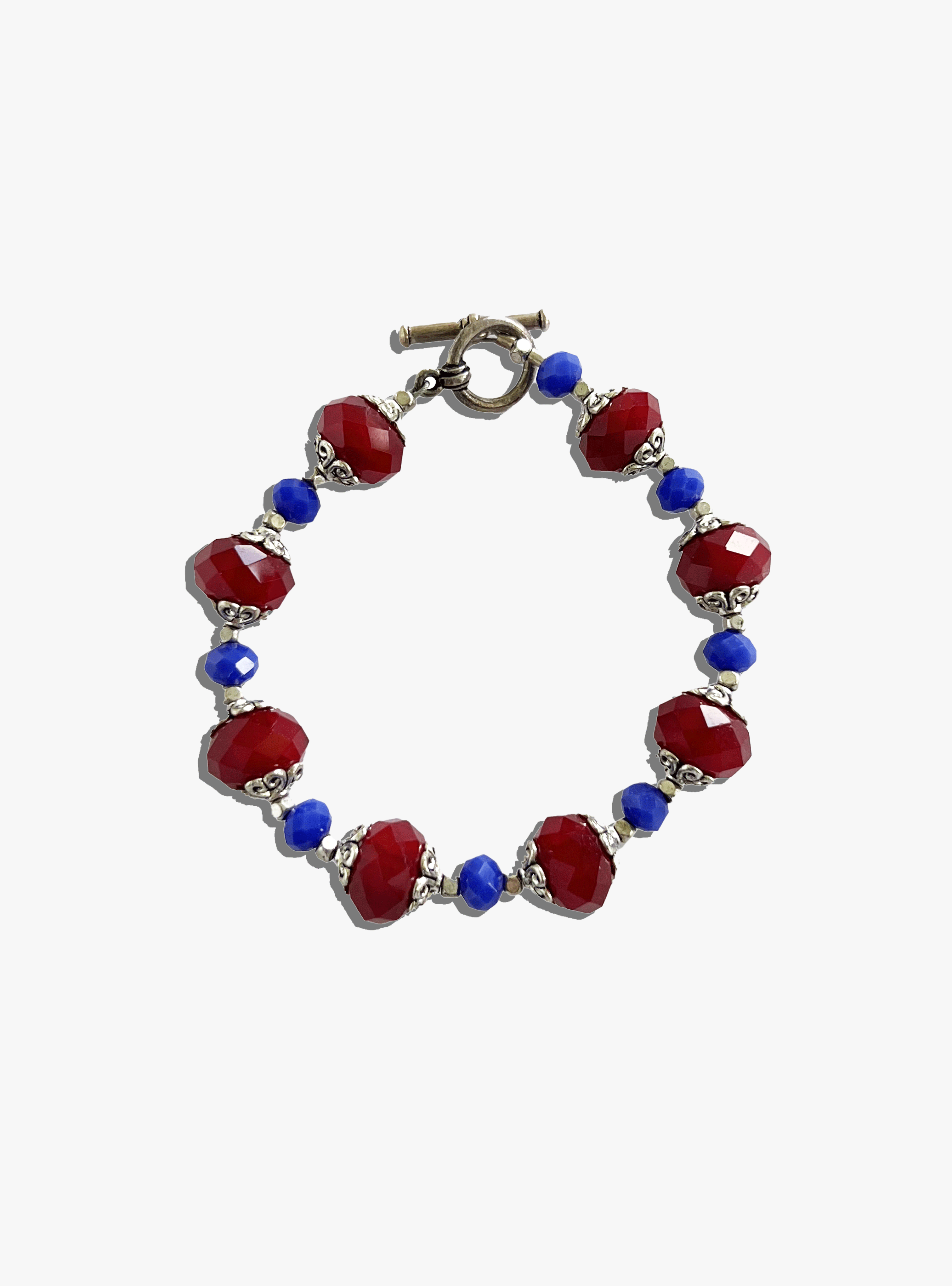 Bracelet with red and blue beads on a white background