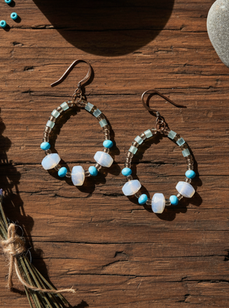 Pair of hoop earrings with beads on a wooden surface